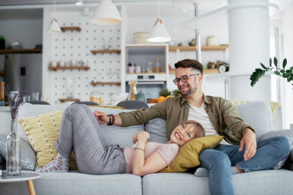 happy couple wife sleeping at husband lap in sofa