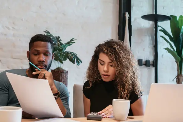 Diverse couple working on a business plan together.