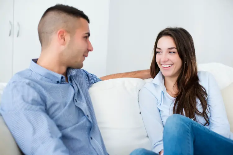 Young couple talking and laughing in sofa